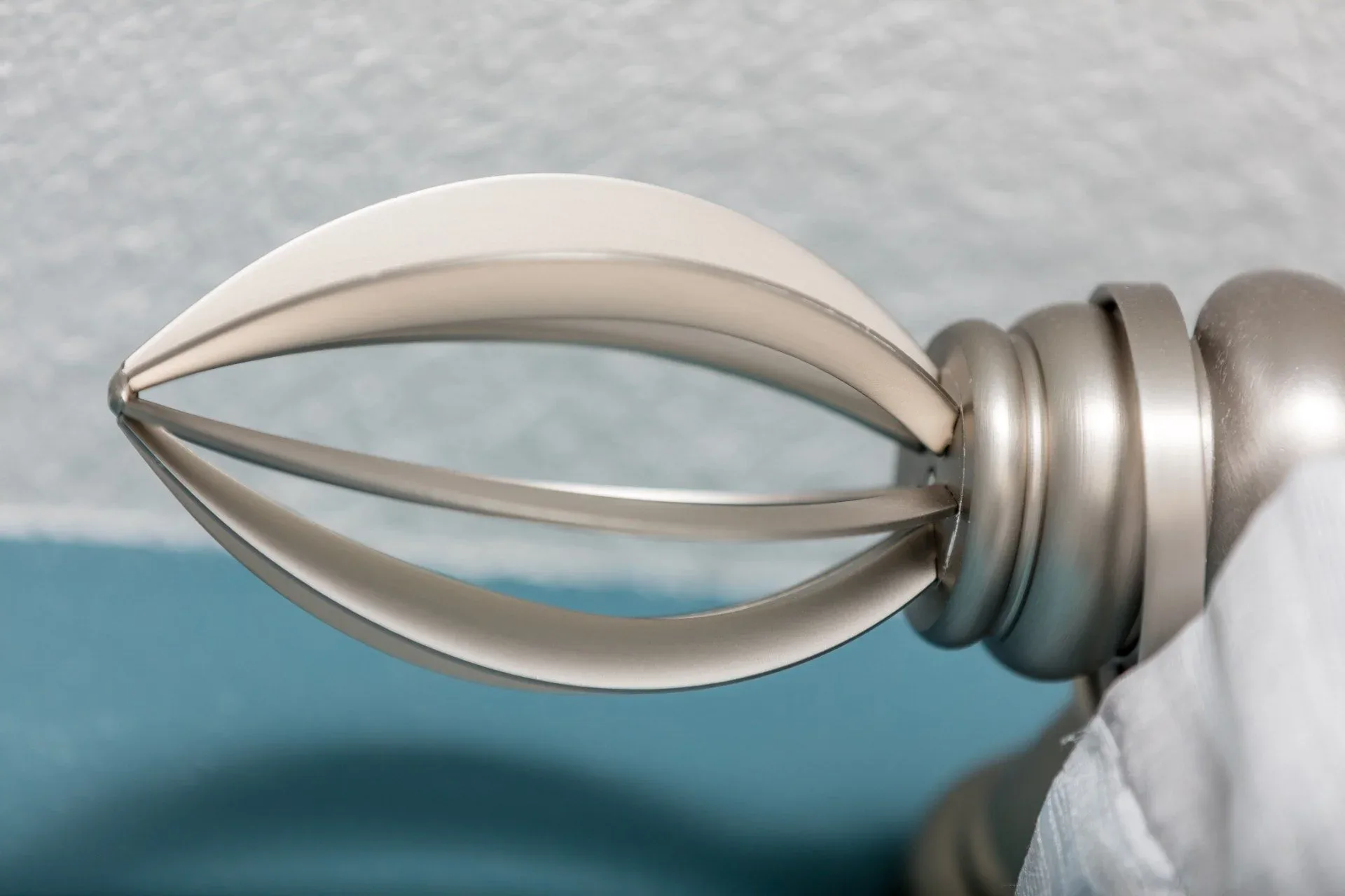 Brushed nickel caged drapery-rod finial specified by Custom Fabric Creations in St. Petersburg, FL